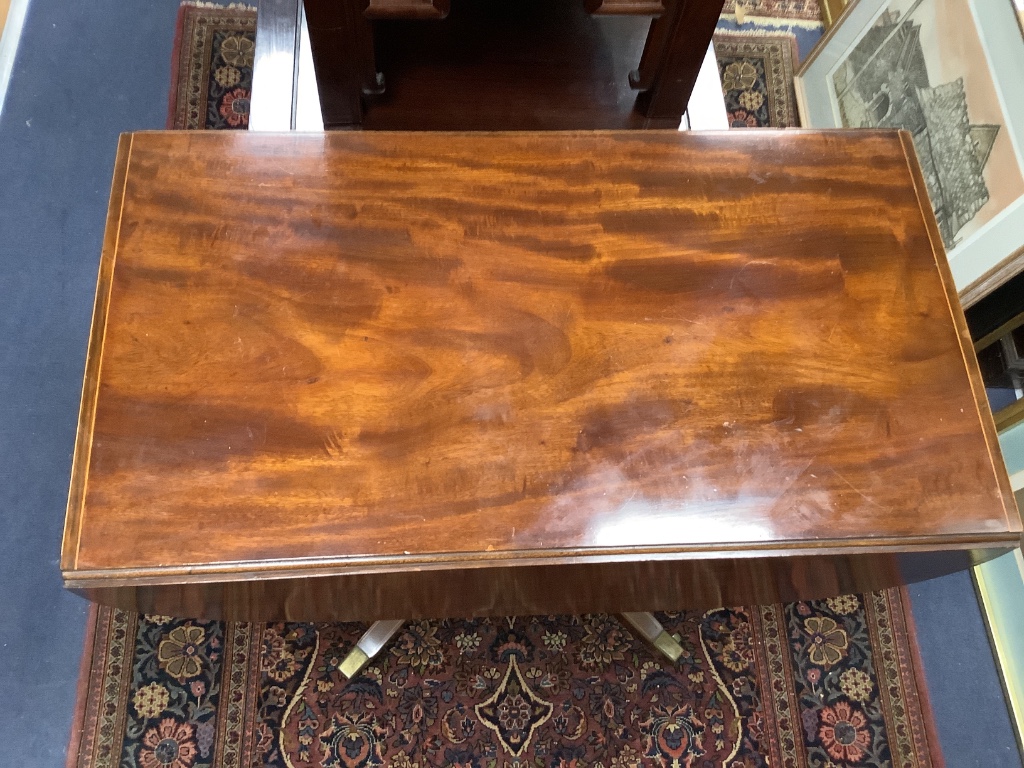 A late Georgian inlaid mahogany pedestal Pembroke table,on quadripartite splayed supports with brass castors, width 92cm depth 52cm height 70cm